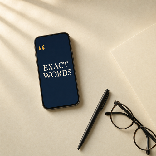Exact Words open on a phone beside a pen and reading glasses